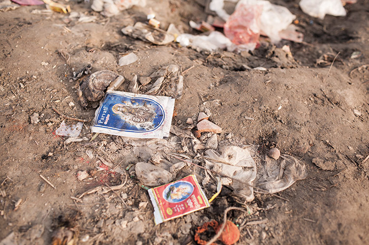 The empty packets of incense and colors in the bank of Yamuna River